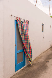 Sicily - Sunny impressions of the Aeolian Islands, also known as Aeolian Islands or Isole Eolie: Lipari, Stromboli, Salina, Vulcano, Panarea, Filicudi and Alicudi. Typical door curtain on Panarea. Sicily - Sunny impressions of the Aeolian Islands, also known as Aeolian Islands or Isole Eolie: Lipari, Stromboli, Salina, Vulcano, Panarea, Filicudi and Alicudi. Typical door curtain on Panarea.